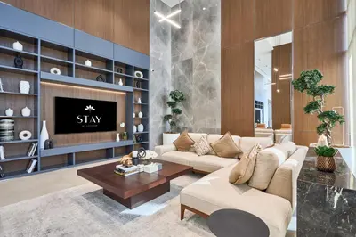 a living room with a couch and a tv at STAY BY LATINEM Luxury 1BR Holiday Home CVG 604 Near Downtown in Dubai