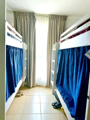 two bunk beds in a room with a window at WAHA WOW Bed space Available in Luxury Apartment in Sabkhah
