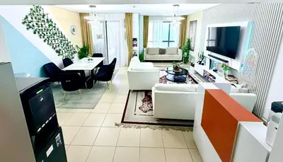 a living room with a couch and a table at WAHA WOW Bed space Available in Luxury Apartment in Sabkhah