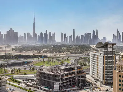 an aerial view of a city with a tall building at Livin' Holidays - 2BR - Skyline View with Burj Glimpse in Dubai