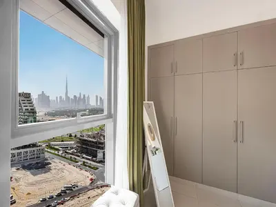a room with a window with a view of a city at Livin' Holidays - 2BR - Skyline View with Burj Glimpse in Dubai
