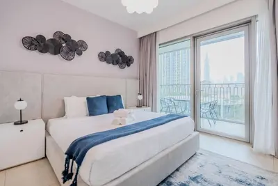 a bedroom with a large bed and a large window at TRPS - Downtown Views II T2, Downtown Dubai - Modern 3BR Home, Maids Room, Full Burj Khalifa View in Dubai