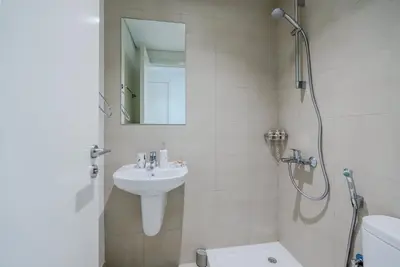 a bathroom with a sink and a shower and a toilet at TRPS - Downtown Views II T2, Downtown Dubai - Modern 3BR Home, Maids Room, Full Burj Khalifa View in Dubai