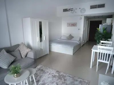 a living room with a couch and a table at Sunsand Studio at Dubai Marina in Dubai