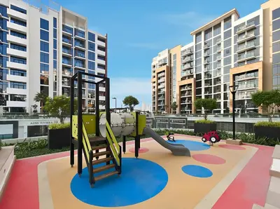 a playground in a city with tall buildings at Chic Modern Studio in Meydan Azizi Riviera 26 in Dubai