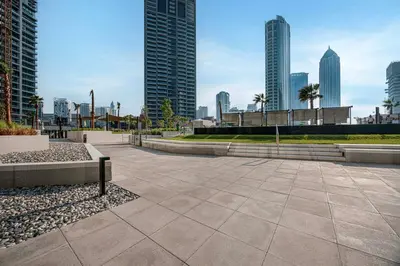 a walkway in a city with tall buildings at LUX 1 BDR apartment Downtown - Burj Khalifa view in Dubai