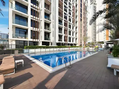 a swimming pool in the middle of a building at Bright Modern Studio in Meydan Azizi Riviera 40 in Dubai