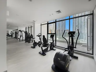 a gym with treadmills and ellipticals in a building at Bright Modern Studio in Meydan Azizi Riviera 40 in Dubai