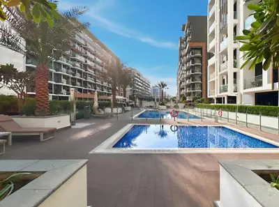 a swimming pool in the middle of a building at Bright Modern Studio in Meydan Azizi Riviera 40 in Dubai
