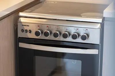 a stove top oven sitting inside of a kitchen at Luxury Downtown 2 Bedroom Apartment with amazing Burj and Fountain Views and Private Jacuzzi on a large Terrace in Dubai