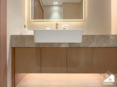 a bathroom with a white sink and a mirror at 2BR Panoramic Skyline Haven with Jacuzzi in Dubai