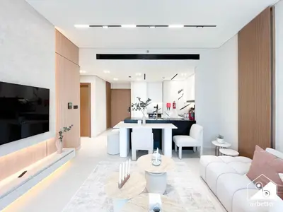 a living room with a white couch and a table at 2BR Panoramic Skyline Haven with Jacuzzi in Dubai