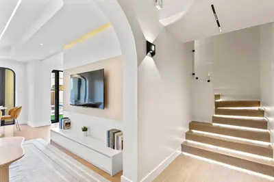 a staircase in a house with white walls at Cozy 2Bedroom Villa with Private Pool in Springs in Dubai