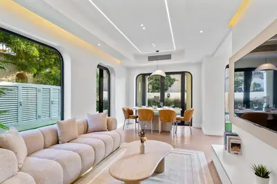 a living room with a large couch and a table at Cozy 2Bedroom Villa with Private Pool in Springs in Dubai