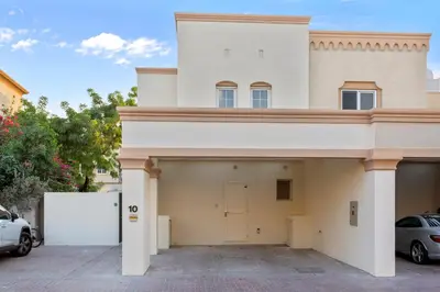 a large white house with a garage at Cozy 2Bedroom Villa with Private Pool in Springs in Dubai