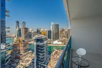 a view of a city from the balcony of a building at Spacious apt City view Gym and pool in Dubai