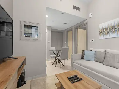 a living room with a couch and a table at Zada Glam Sleek 1BDR Retreat-Business Bay-25 in Dubai
