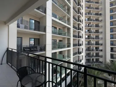 an apartment balcony with two chairs and a building at Zada Glam Sleek 1BDR Retreat-Business Bay-25 in Dubai