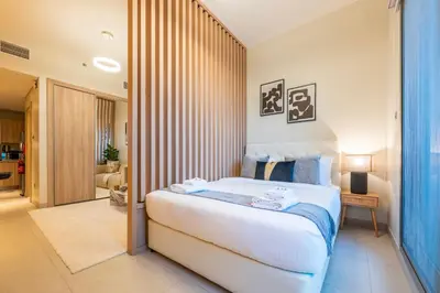 a bedroom with a large white bed in a room at Exquisite Studio by UDH Sway Residence at Dubai Hills in Dubai