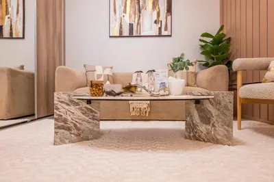 a living room with a stone coffee table at Exquisite Studio by UDH Sway Residence at Dubai Hills in Dubai
