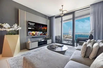 a living room with a couch and a tv at Address Beach Resort 3 Bedroom with Sea and Palm Views in Dubai