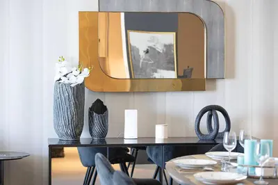 a dining room with a table with chairs and a mirror at Address Beach Resort 3 Bedroom with Sea and Palm Views in Dubai