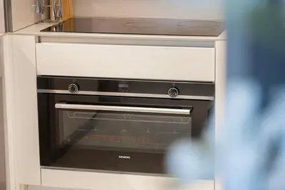 a kitchen with an oven in a cabinet at Address Beach Resort 3 Bedroom with Sea and Palm Views in Dubai