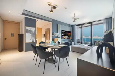 a living room with a table and chairs and a couch at Address Beach Resort 3 Bedroom with Sea and Palm Views in Dubai