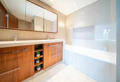 a bathroom with a sink and a tub and a mirror at Luxury 2 Bed in Boulevard Point with City Views in Dubai
