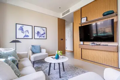 a living room with a couch and a tv at Frank Porter - Address Residences Dubai Opera Tower 1 in Dubai
