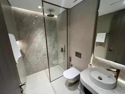 a bathroom with a shower and a toilet and a sink at Amazing Dubai Silicon Oasis Rental Apartments in Dubai
