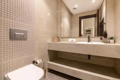 a bathroom with a sink and a toilet and a mirror at BLVD - Stunning Full Burj Khalifa Firework Views in Dubai