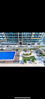 a view of a large building with a swimming pool at Holiday homes azizi riviera in Dubai