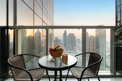 a table with a bowl of fruit on top of a window at Gogoto5 1BR Burj View Infinity Pool High Floor in Dubai