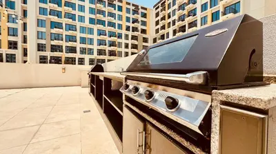 a bbq grill on a counter in a city at Premium Guest - Liva Serenity Suite in Dubai