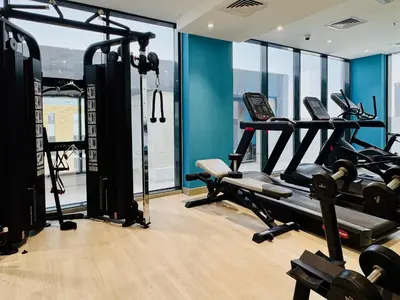 a gym with two tread machines in a room at Premium Guest - Dubai Riviera in Dubai