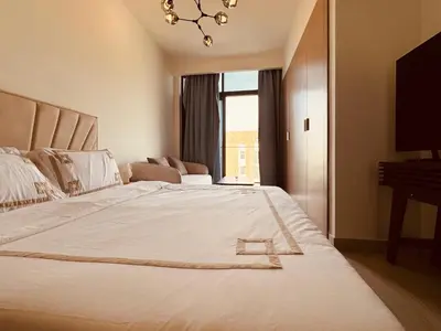 a bedroom with a large white bed with a window at Premium Guest - Dubai Riviera in Dubai