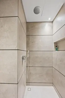 a bathroom with a shower with a shower head at Luxury Studio with Balcony in JVC in Dubai