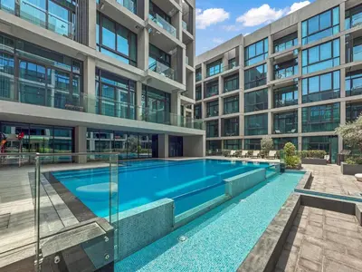 an empty swimming pool in front of a building at Luxury Studio with Balcony in JVC in Dubai