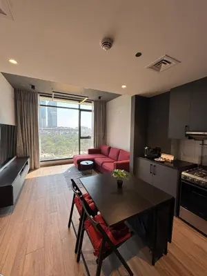 a living room with a table and a red couch at Peaceful Modern Home Overlooking JVC Green Park in Dubai