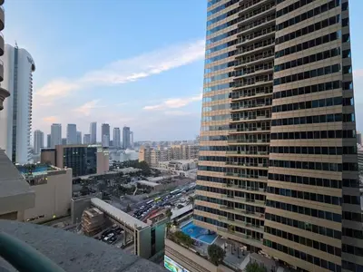 a view of a city with a tall building at Luxury Furnished 2 BR with Stunning Sea View in Dubai