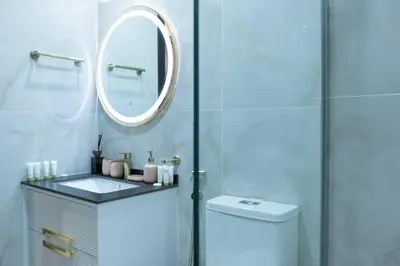 a bathroom with a toilet and a sink and a mirror at Gemz by Danube, Private Pool, Al Furjan - Onelink in Dubai