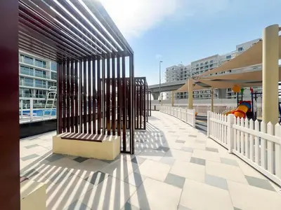a train station with a bench in a metal cage at Gemz by Danube, Private Pool, Al Furjan - Onelink in Dubai