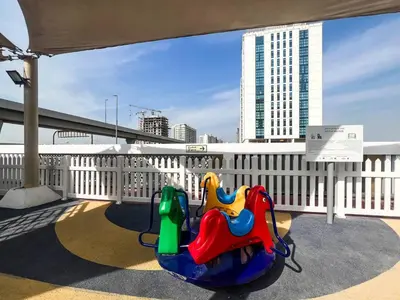 a childs ride on a balcony with a building at Gemz by Danube, Private Pool, Al Furjan - Onelink in Dubai
