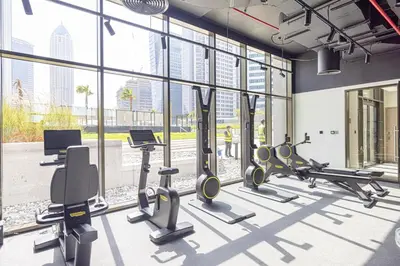 a gym with treadmills and cardio equipment in a building at Trendy & Brand new Studio In Business Bay in Dubai