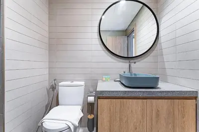 a bathroom with a toilet and a mirror at Trendy & Brand new Studio In Business Bay in Dubai