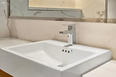 a white sink in a bathroom with a mirror at Estudio Pearl en Dubai by beBalmy in Dubai