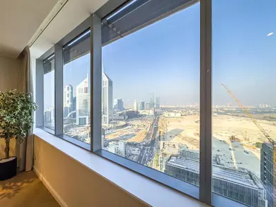 an office window with a view of a city at Designer's Selection - Luxury in the Heart of DIFC in Dubai