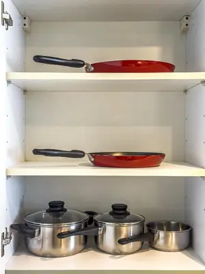 a shelf with pots and pans in a kitchen at Designer's Selection - Luxury in the Heart of DIFC in Dubai