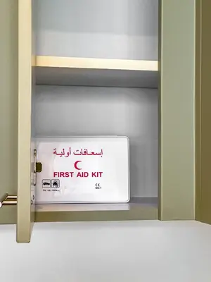 a sign on the door of a door with the words first aid kit at Designer's Selection - Luxury in the Heart of DIFC in Dubai
